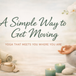 Soft, calming yoga scene with a person seated in a relaxed pose, surrounded by a mat, blocks, and candles, representing gentle, approachable movement and a simple way to start exercising.